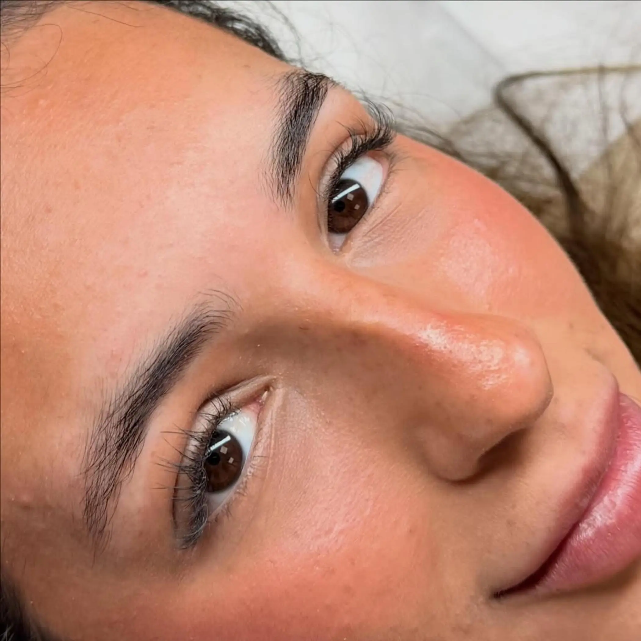 artist mapping eyebrows during consultation