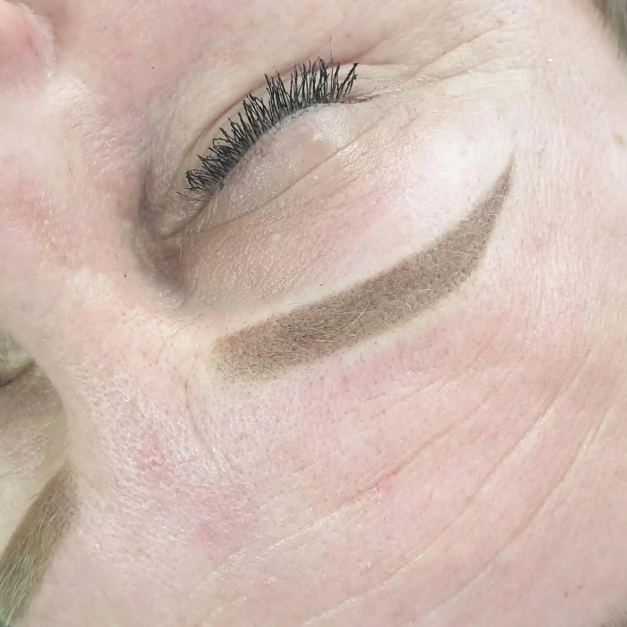 cosmetic tattoo artist performing procedure