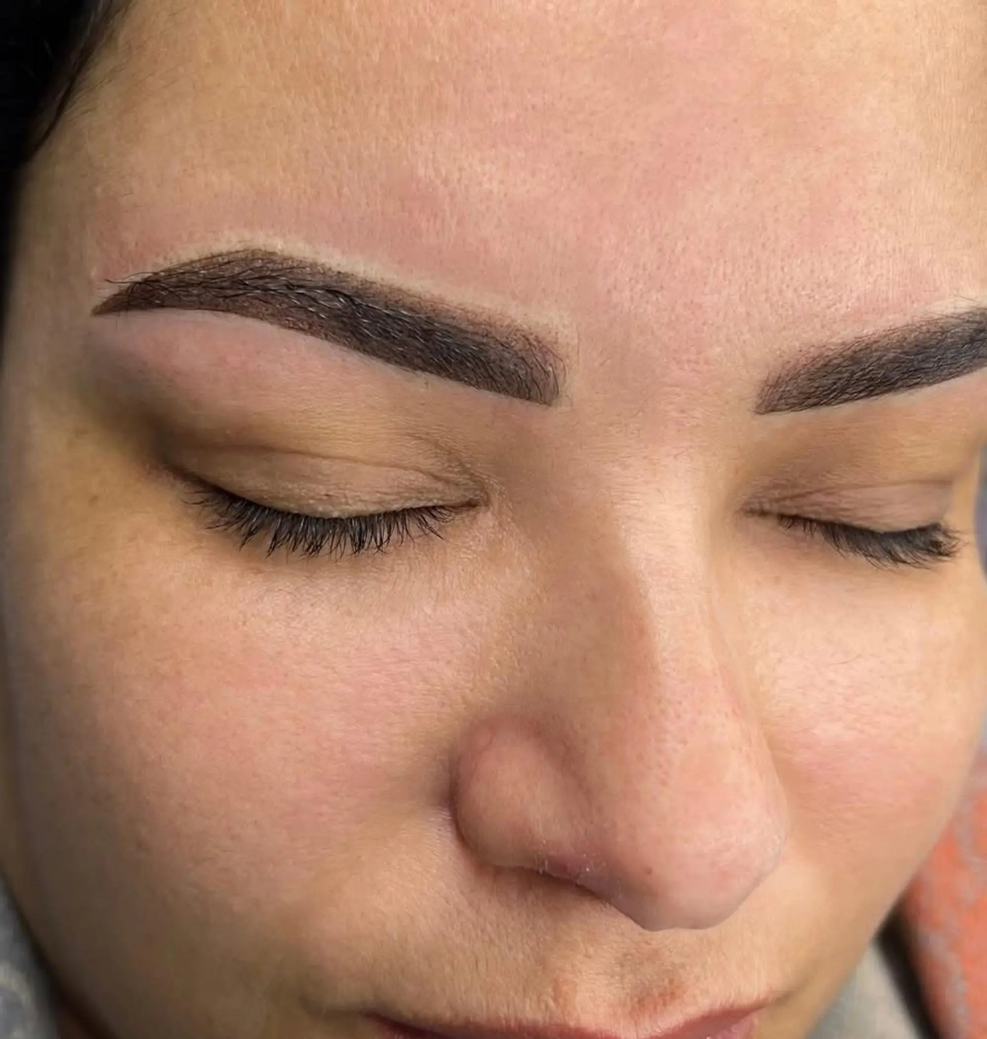 technician performing powder brow procedure