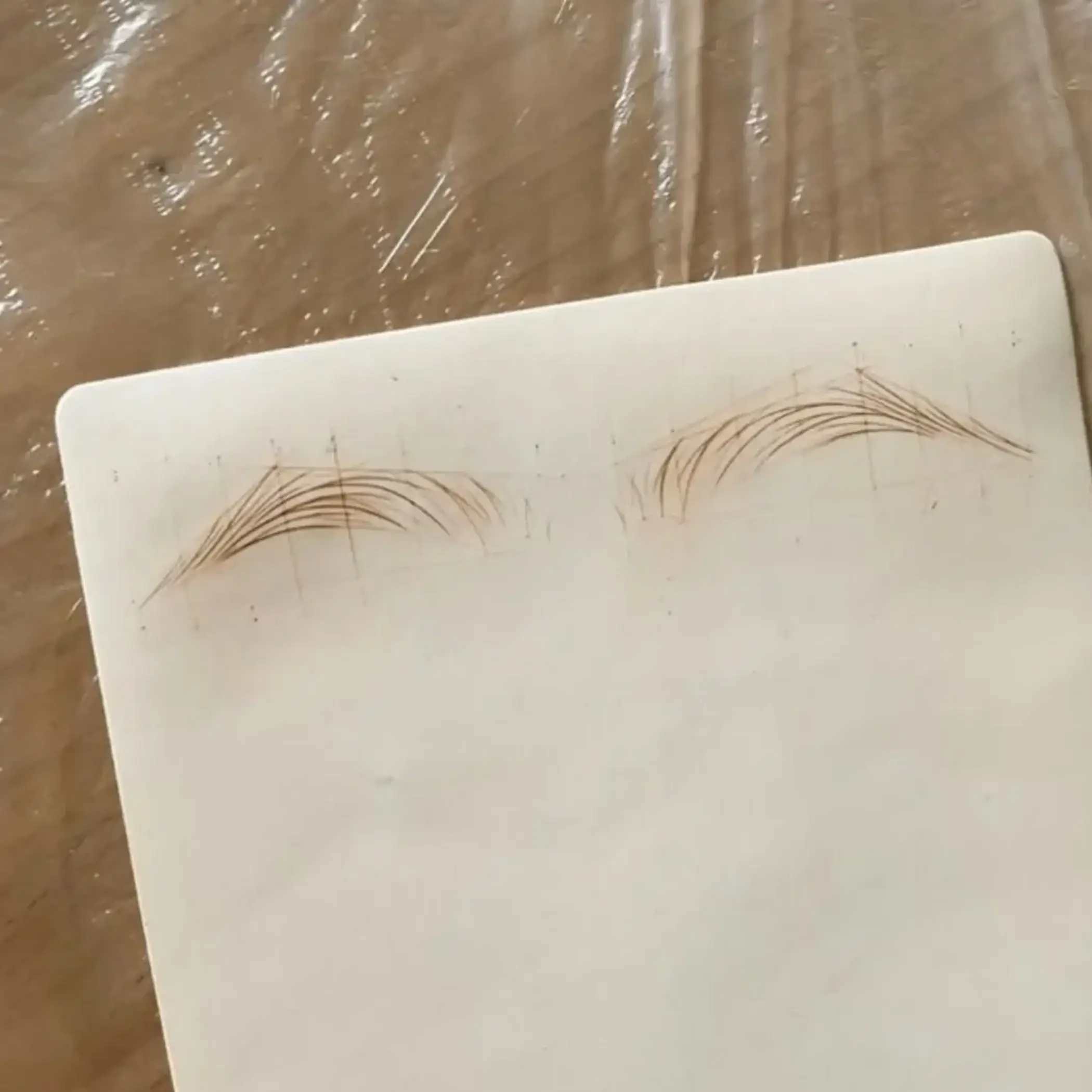 technician shaping eyebrows with caliper